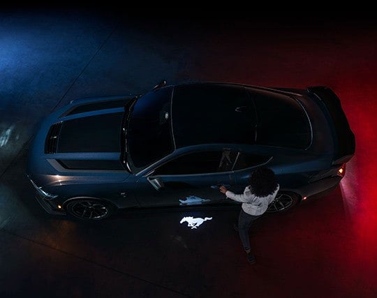 2024 Ford Mustang® Dark Horse™ model with a driver approaching the vehicle | Jim Hudson Ford in Lexington SC